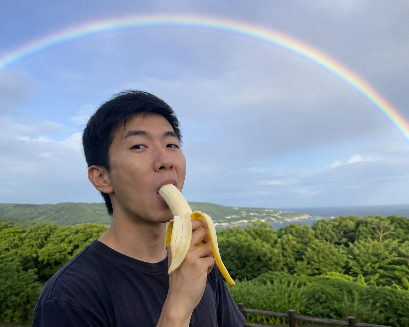 Asian man eating a banan under a rainbow May 2026